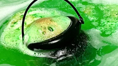 Bath bomb cauldron izzing green in water