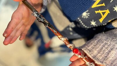 Proud wizard holding his newly made wand