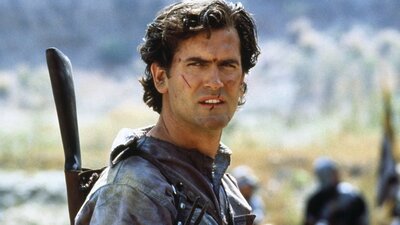 Army of Darkness (1992) Man looks past camera with cuts on his face, dressed ready for battle