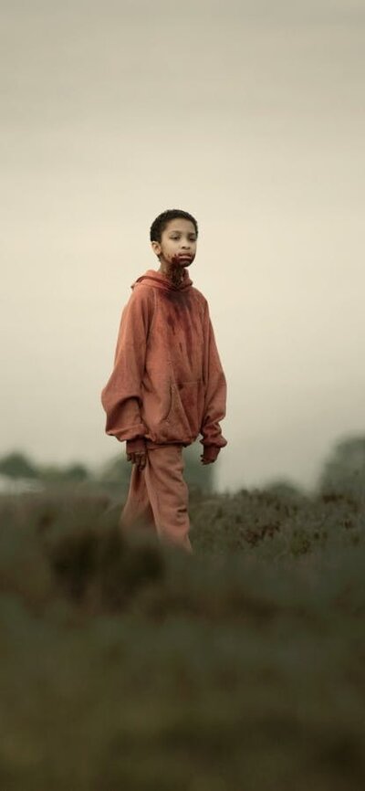 Science. Art. Film.: The Girl with All the Gifts 26 October, 2026 Young child with shaved head stands in isolated surrounds with blood around mouth