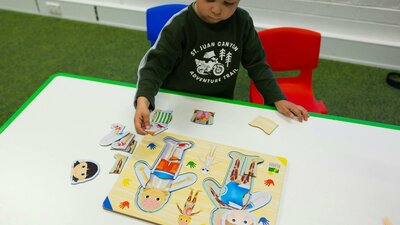 A young boy completing a human body puzzle at Science Time A young boy completing a human body puzzle