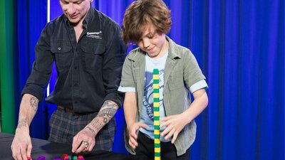 A man and a boy explore patterns using coloured blocks