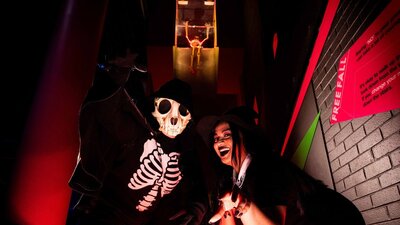 People dressed up in Halloween costumes standing at the bottom of Questacon's Free Fall Slide