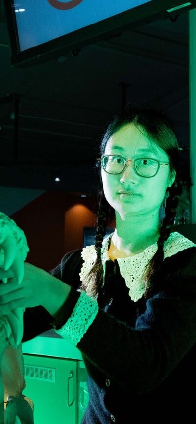People dressed in Halloween costumes posing with Questacon's skull collection