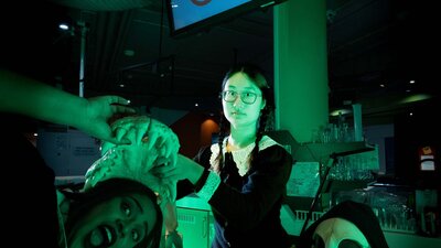 People dressed in Halloween costumes posing with Questacon's skull collection