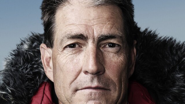Headshot of Professor John Priscu in a red, weatherproof jacket with hood,