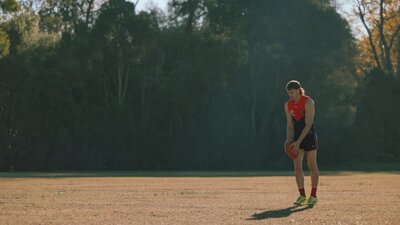 Man on field getting ready to kick a football