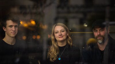 Za Górami © Monika Jakubowska, 2023 ECM Records A young man, blonde-haired woman and bearded man smiling
