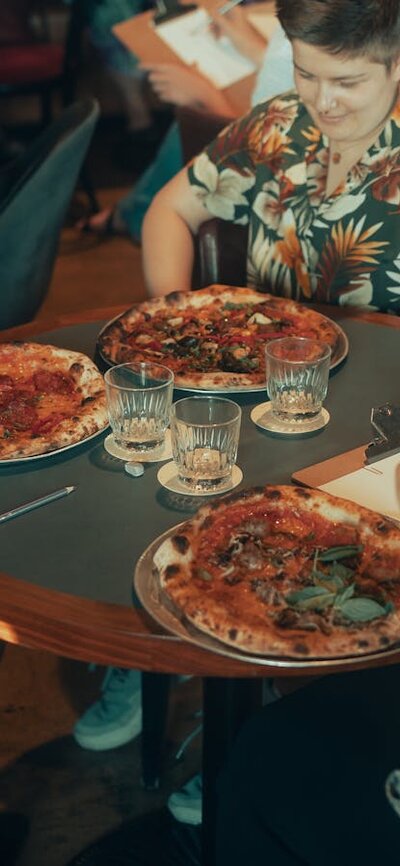 People sitting around a table eating pizza