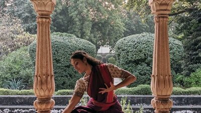 Woman in sari kneeling in temple