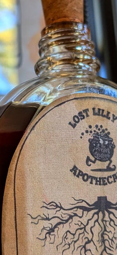 Potions bottles for making cocktails. This one is labelled "Extract of Smilax Root".