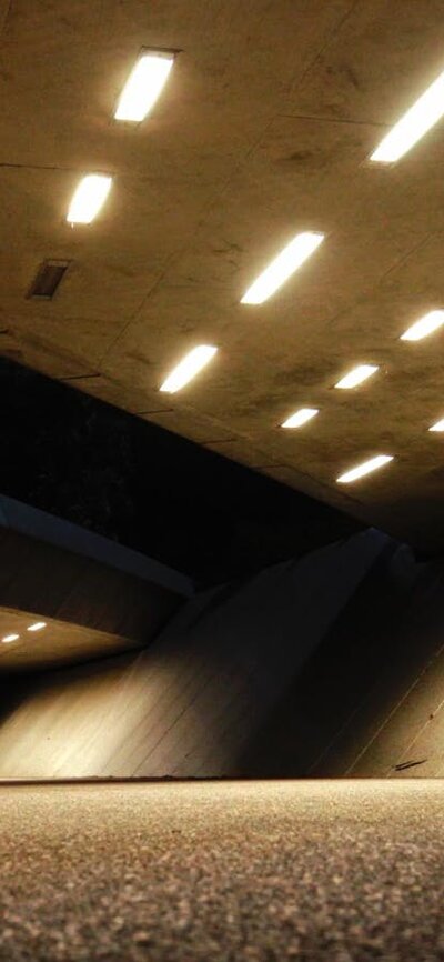 SPHERE will be an immersive dance and film experience On the left is a large concrete underpass, lit up at night. Two small figures are locked together