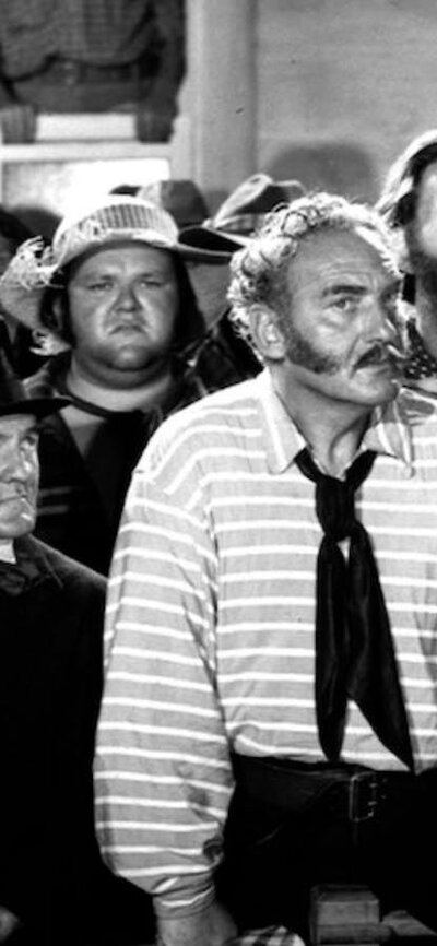 Black and white still from Eureka Stockade showing a group of people in period attire