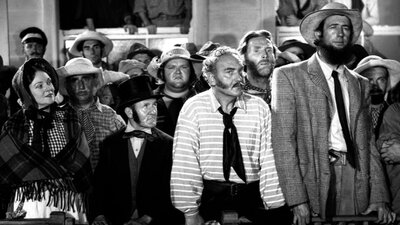 Black and white still from Eureka Stockade showing a group of people in period attire