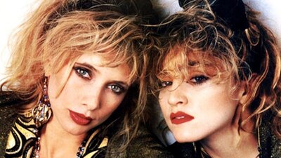 Portrait of two similar-looking women dressed in 1980s fashion