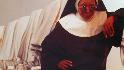 Still from Sister Act showing a woman dressed in a nun's habit wearing sunglasses