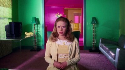 But I'm a Cheerleader 01 October, 2026 Woman sits in preppy outfit with her mouth open, pink door in background