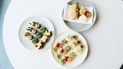 Birds eye view of three high tea plates featuing scones, cakes and small goods
