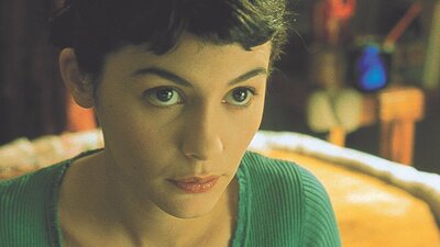 Amélie (2001) Woman with dark hair and green top looks up at the camera