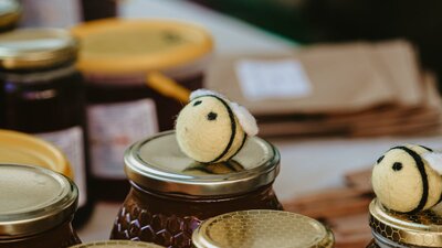Bees on top of honey jars at Haig Park Vil