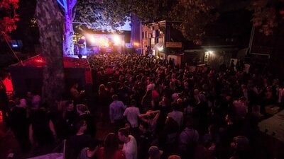 Crowd of people dancing at an outdoor stage