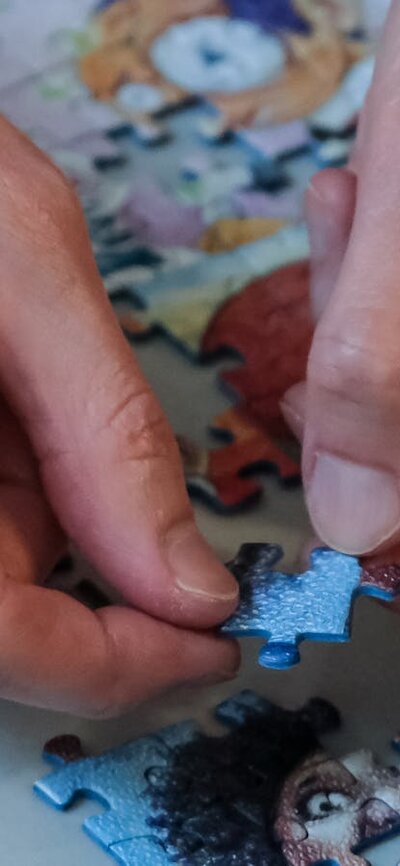 Hands completing a puzzle