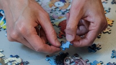 Hands completing a puzzle