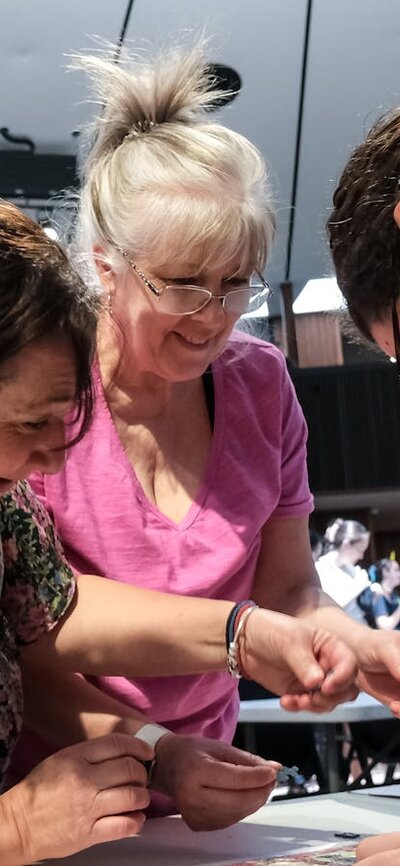 Three women puzzling together