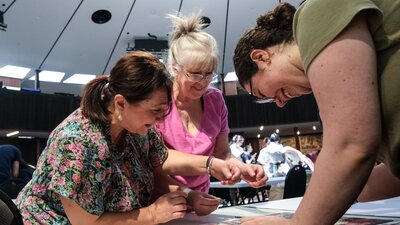 Three women puzzling together