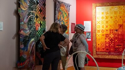 Group observing quilts at Stitching Stories