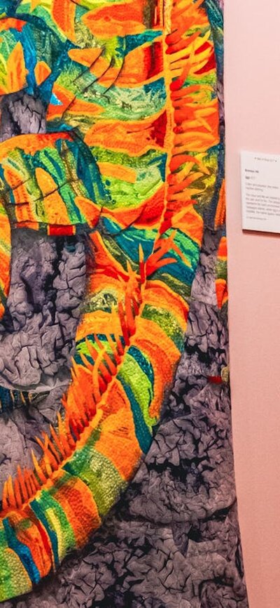 Iggy quilt by Bronwyn Hill. Bright iguana quilt with colourful embroidery and patchwork