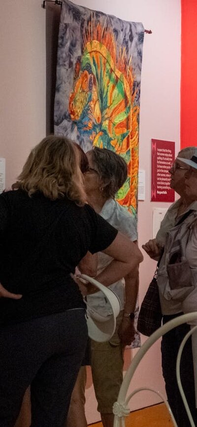 Group observing quilts at Stitching Stories