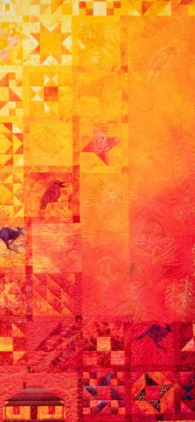 The Quiltmaker quilt by Jenny Bowker depicting Margaret Rolfe in bright yellows, oranges and reds