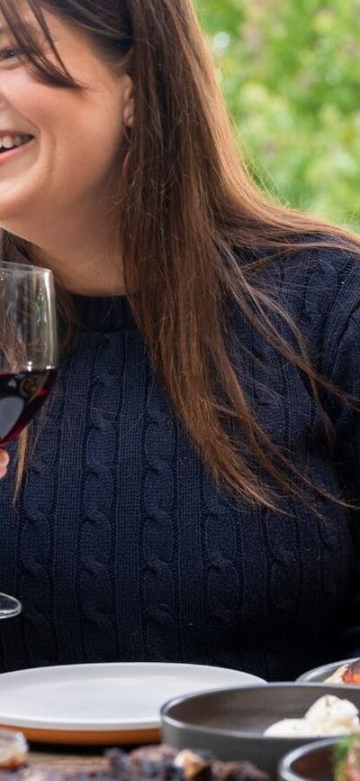Food and Wine Woman with wine glass sitting at table