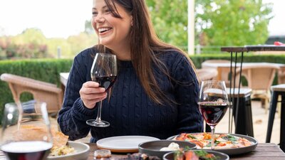 Food and Wine Woman with wine glass sitting at table