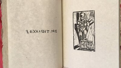 An open book with a drawing of a person and text that reads 'Exhibit me'.