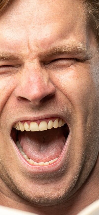 A man surrounded by books, excited