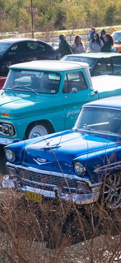 Classic cars parked in lines ready to drive in the Classic Cruise