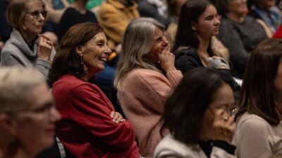 Crowd of people sitting in a theatre