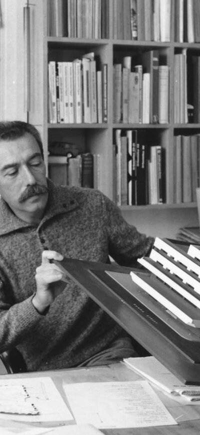 Enrico Taglietti inspecting an architectural model in his studio