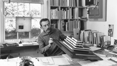 Enrico Taglietti inspecting an architectural model in his studio
