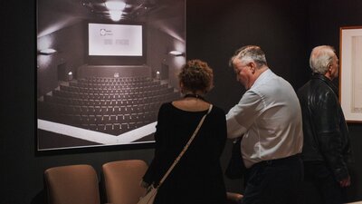 People exploring the Taglietti exhibition looking at Center Cinema installations