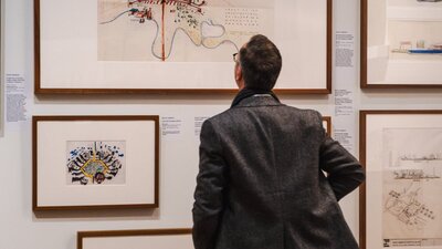 Man looking at Taglietti architectural sketches