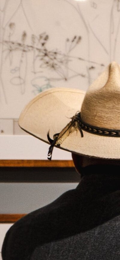 Man looking at architectural sketches in the Taglietti exhibition