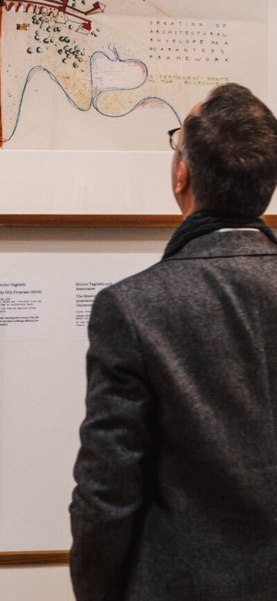 Man looking at Taglietti architectural sketches