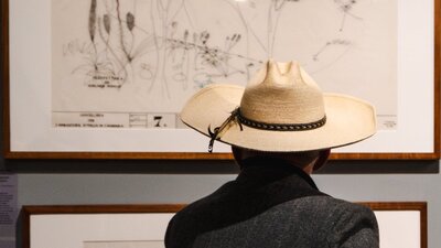Man looking at architectural sketches in the Taglietti exhibition