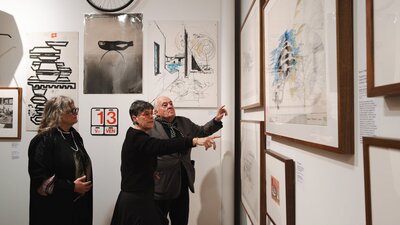 People exploring the Taglietti exhibition