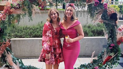 Two women dressed up for the races.