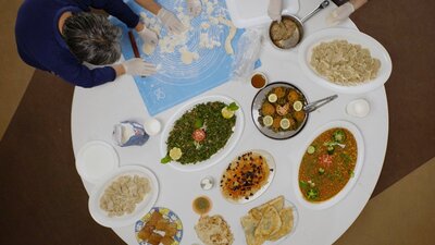Arial view of people around a round table full of platters of food