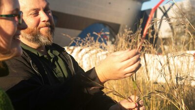 Adam Shipp Adam Shipp smiles as he holds native grasses outdoors during a guided cultural experience.